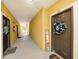Hallway view with unit doors, welcome signs, and an open balcony at 10017 Courtney Palms Blvd # 301, Tampa, FL 33619