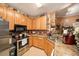 Bright kitchen showcasing stainless steel appliances, wooden cabinets, and a breakfast bar for a cozy cooking space at 10017 Courtney Palms Blvd # 301, Tampa, FL 33619