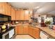 Charming kitchen featuring stainless steel appliances, wooden cabinets, and plenty of counter space at 10017 Courtney Palms Blvd # 301, Tampa, FL 33619