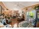 Open concept living room showcasing hardwood floors, a sunroom, and dining area at 10017 Courtney Palms Blvd # 301, Tampa, FL 33619