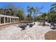 Charming outdoor patio area with fire pit, seating, and lush landscaping at 10017 Courtney Palms Blvd # 301, Tampa, FL 33619