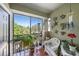 Relaxing screened patio with plants, wicker furniture, and view of lush landscaping at 10017 Courtney Palms Blvd # 301, Tampa, FL 33619