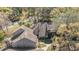 An aerial view showcases the property's roof, chimney, landscaping, and proximity to a tree-lined neighborhood at 102 Old Mill Pond Rd, Palm Harbor, FL 34683