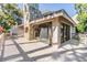 Back of house with large stone fireplace and chimney at 102 Old Mill Pond Rd, Palm Harbor, FL 34683
