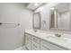 Bright bathroom featuring double sinks, white cabinets, and large mirrors at 102 Old Mill Pond Rd, Palm Harbor, FL 34683