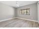 This bedroom features light gray walls, light wood-look flooring, and a ceiling fan at 102 Old Mill Pond Rd, Palm Harbor, FL 34683