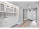 Inviting entryway features a wet bar with white cabinets, modern fixtures, and a decorative wine rack at 102 Old Mill Pond Rd, Palm Harbor, FL 34683
