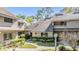 Attractive condominium with a well-manicured lawn and mature trees at 102 Old Mill Pond Rd, Palm Harbor, FL 34683
