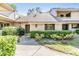 Charming condo showcasing tidy landscaping and a welcoming walkway at 102 Old Mill Pond Rd, Palm Harbor, FL 34683
