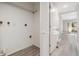 A shot of the hallway with doors, light gray walls, and light wood-look flooring at 102 Old Mill Pond Rd, Palm Harbor, FL 34683