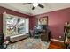 Cozy office space with burgundy walls, bright windows, and colorful rug at 10632 Weybridge Dr, Tampa, FL 33626