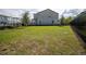 View of backyard, with the house, fence, and lawn visible at 11221 Beach Walk Ne Way, St Petersburg, FL 33716