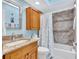 Bathroom featuring granite countertops, tiled shower and a built-in cabinet for extra storage space at 11430 94Th St, Largo, FL 33773