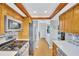 Well-lit kitchen featuring stainless steel appliances, tile backsplash, and wood-look flooring at 11430 94Th St, Largo, FL 33773