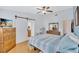 A comfortable main bedroom with a barn door to the bath, wood floors, and great closet access at 11430 94Th St, Largo, FL 33773