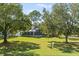 Sprawling lawn with mature trees and fenced backyard with patio at 12227 Glencliff Cir, Tampa, FL 33626