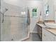 Bathroom featuring a glass shower with tile surround, updated fixtures, and a modern vessel sink vanity at 12227 Glencliff Cir, Tampa, FL 33626