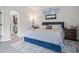 Stylish bedroom featuring a comfortable blue bed and walk-in closet at 12227 Glencliff Cir, Tampa, FL 33626