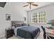 Cozy bedroom with a ceiling fan, natural light, and a work space at 12227 Glencliff Cir, Tampa, FL 33626