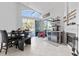 Dining area with a fireplace, beverage center, and view of the pool outside at 12227 Glencliff Cir, Tampa, FL 33626