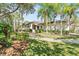 Beautiful home with lush landscaping, mature trees, and a well-maintained lawn creating a serene and inviting curb appeal at 12227 Glencliff Cir, Tampa, FL 33626