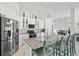 Modern kitchen featuring white cabinets, stainless steel appliances, and granite countertops, offering both style and functionality at 12227 Glencliff Cir, Tampa, FL 33626