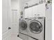 Modern laundry room features updated washer and dryer units and ample storage space at 12227 Glencliff Cir, Tampa, FL 33626