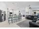 Open-concept living room and kitchen with modern appliances and ample counter seating at 12227 Glencliff Cir, Tampa, FL 33626