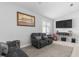 Cozy living room featuring neutral paint, a comfortable couch, and a wall-mounted TV at 12227 Glencliff Cir, Tampa, FL 33626