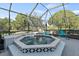 Covered patio features a hot tub, plenty of seating, and views of the golf course at 12227 Glencliff Cir, Tampa, FL 33626