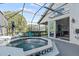 Covered patio features a spa and sliding glass doors to the interior at 12227 Glencliff Cir, Tampa, FL 33626