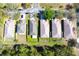 An aerial view of several homes in a quiet neighborhood with well-maintained lawns and mature trees at 12652 Chenwood Ave, Hudson, FL 34669