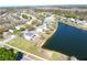 Aerial view of a residential neighborhood with lake, showcasing single-Gathering homes and green spaces at 12652 Chenwood Ave, Hudson, FL 34669