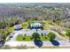Aerial view of community pool and clubhouse with parking at 12652 Chenwood Ave, Hudson, FL 34669
