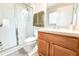Bathroom featuring a glass-enclosed shower, tile flooring, and a single sink vanity at 12652 Chenwood Ave, Hudson, FL 34669