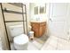 Bathroom featuring a toilet, single sink vanity and tiled floor at 12652 Chenwood Ave, Hudson, FL 34669
