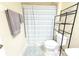 Standard bathroom setup featuring toilet, shelving, and gray-striped shower curtain at 12652 Chenwood Ave, Hudson, FL 34669