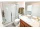 Bathroom featuring a walk-in shower with sliding glass doors and vanity with sink at 12652 Chenwood Ave, Hudson, FL 34669