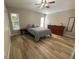Bright bedroom with ample floor space, featuring wood-look floors and natural lighting at 12652 Chenwood Ave, Hudson, FL 34669