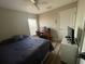 Inviting bedroom with ceiling fan, desk setup, and bright natural light at 12652 Chenwood Ave, Hudson, FL 34669