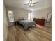 Bright bedroom with ample floor space, featuring wood-look floors and natural lighting at 12652 Chenwood Ave, Hudson, FL 34669