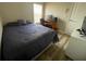 Cozy bedroom featuring a bed, desk setup, and wood-look floors at 12652 Chenwood Ave, Hudson, FL 34669