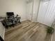 Bright bedroom featuring wood-look floors, natural light, and closet at 12652 Chenwood Ave, Hudson, FL 34669