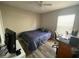 Well-lit bedroom with desk and entertainment unit, showcasing the wood-look floors at 12652 Chenwood Ave, Hudson, FL 34669