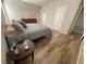 Spacious bedroom featuring wood-look floors, dresser, closet and natural light at 12652 Chenwood Ave, Hudson, FL 34669