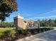 Stone sign marking the entrance to The Verandahs community surrounded by lush landscaping at 12652 Chenwood Ave, Hudson, FL 34669