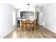 Bright dining area with wood-look floors, connecting to the kitchen for easy entertaining at 12652 Chenwood Ave, Hudson, FL 34669