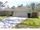 Attractive single-story home with a spacious driveway leading to an attached two-car garage at 12652 Chenwood Ave, Hudson, FL 34669