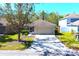 Charming single-story home featuring a well-manicured lawn and a spacious two-car garage at 12652 Chenwood Ave, Hudson, FL 34669