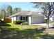Charming one-story home with a two-car garage, screened porch, and green front lawn at 12652 Chenwood Ave, Hudson, FL 34669